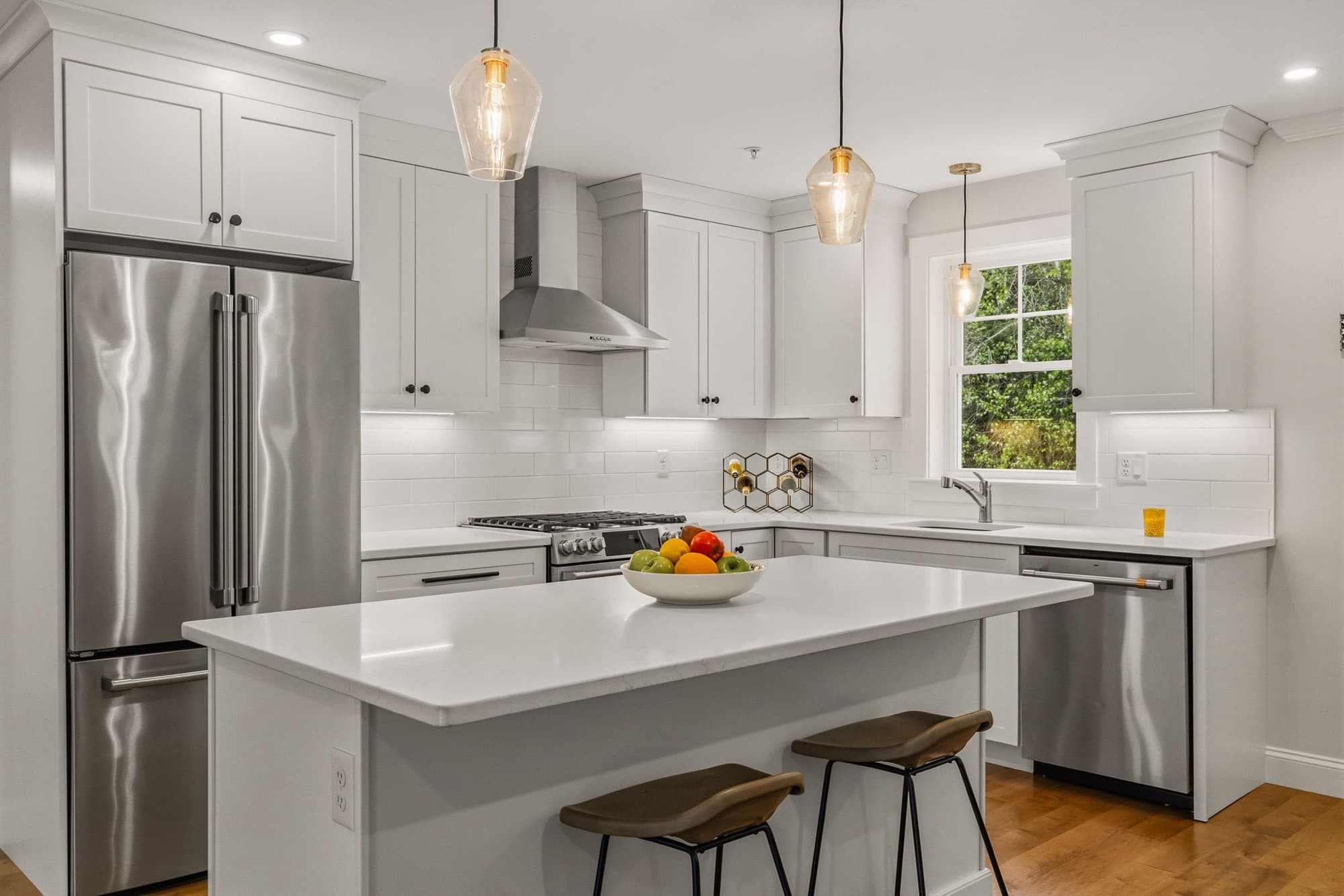 Kitchen with a quartz island, stainless appliances, and pendant lighting