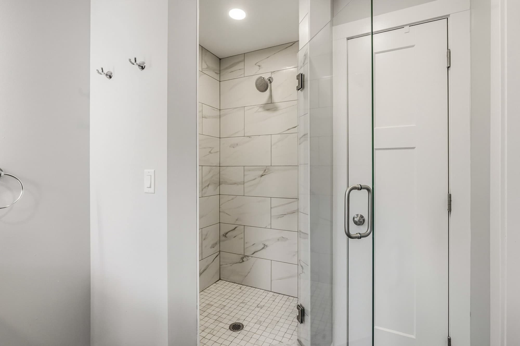 Primary bathroom walk-in shower with custom tile
